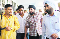 Baksheesh Singh (second from right) being produced in a court in Karnal 