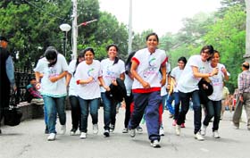 Girls running a marathon organised by the CMC Vatavaran at Shimla on Wednesday.