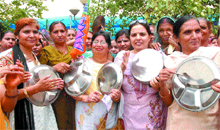 BJP workers bang thalis to protest against price rise in Jalandhar on Wednesday.
