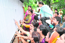 Students search for their names in the first merit list at Government College for Women, Gandhi Nagar, in Jammu on Wednesday.