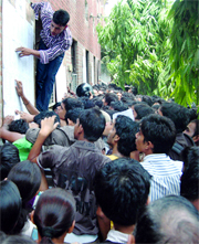 Students rush to see the third cut-off list at Arts Faculty, Delh University, on Thursday.
