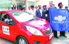 Karl Slym, MD and President of General Motors, flags off a car rally in Amritsar on Friday