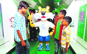 Children gear up to the spirit of Cwealth Games with Shera, the mascot, at an exhibition train in Chandigarh on Friday.