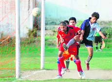A Match in progress at the Lala Nemi Dass Memorial Football League in Dehradun on Friday.