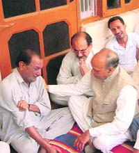 Chief Minister Prem Kumar Dhumal at the home of CRPF jawan Pankaj, who was killed by Naxals, consoling the family at Dehra