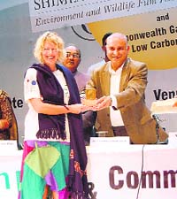 Gulab Singh Thakur, PWD Minister, giving prize to garbage girl Judie Underhills, during the inaugural function of the Shimla CMS Vatavaran Environment and Wildlife Film Festival and Forum 2010 at the Gaiety Theatre in Shimla