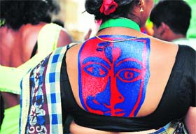  A gay rights activist shows off her body art as she waits to participate in a gay pride event in Bangalore on Friday. The event was organised to celebrate the first anniversary of the Delhi High Court judgment of removal of Section 377 of the IPC, which prohibits "carnal intercourse against the order of nature