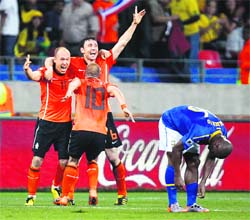 Netherlands Arjen Robben (L), Van Bommel and Wesley Sneijder celebrate after beating Brazil on Friday. 
