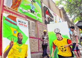 Youngsters decorate their houses with posters of various players of the FIFA World Cup 2010 as soccer fever grips Kolkata