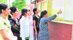 Students take a look at the admission list for the BCA, displayed at MCMDAV College, Sector 36, Chandigarh