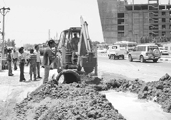 A JCB machine removes an illegal drain connection along the Chandigarh-Ambala Highway 