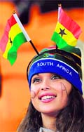 A Ghanaian fan wearing national flags cheers prior to the Uruguay vs Ghana quarterfinal in Johannesburg on Friday