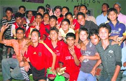 Pavilion B team members show victory sign after lifting the Promotional Football Tournament in Dehradun on Sunday. 