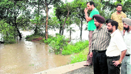District administration officials take stock of the situation arising out of floods in Samrala villages on Sunday.