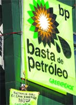 This handout shows Greenpeace activists hanging a huge banner reading "Enough Oil" on the headquarters of the BP company in Alcobendas, near Madrid, on Monday.