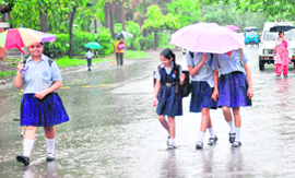 Schoolchildren enjoy the first monsoon shower in Chandigarh