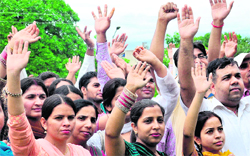 Guest teachers protest in front of the UT education department in Chandigarh