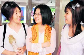 Korean yoga students Chung SO Young, Lee Jung Yi and Da Som Her share a light moment in Haridwar