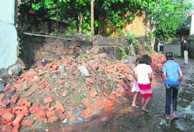 The remains of a wall that fell down due to heavy rains in Dehradun