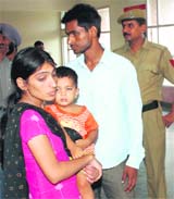 Puja and Mewa Ram, along with their daughter Milan, wait to meet the SP, Karnal, outside his office on Monday.