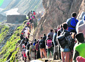 Amarnath pilgrims trudge a treacherous terrain on the Baltal route on Monday.