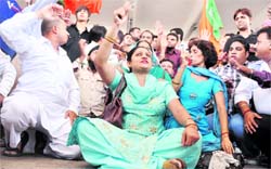 BJP activists hold a protest outside the Ludhiana railway station on Monday