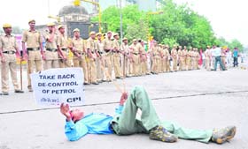 A CPI activist lies on a road during the Bharat Bandh in New Delhi