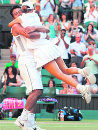 Leander Paes of India (L) and Cara Black of Zimbabwe celebrate after beating Wesley Moodie of South Africa and Lisa Raymond of the US in the mixed doubles final at the Wimbledon Tennis Championships in south-west London on Sunday.