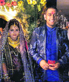 Indian cricket captain Mahendra Singh Dhoni and his childhood friend Sakshi Singh Rawat at their marriage ceremony in Dehradun on Monday.