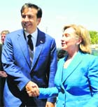 Georgias President Mikheil Saakashvili shakes hands with US Secretary of State Hillary Clinton as they meet in Tbilisi on Monday. 