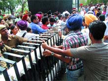 Research scholars close the main gate of of Guru Nanak Dev University, protesting against fee hike on Tuesday. 