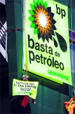 This handout shows Greenpeace activists hanging a huge banner reading "Enough Oil" on the headquarters of the BP company in Alcobendas, near Madrid, on Monday. BPs costs arising from the devastating oil spill in the Gulf of Mexico have rocketed to $3.12 billion, the company revealed on Monday