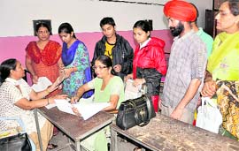 Students and their parents deposit fee for class XI admission at GMSSS, Sector 35, in Chandigarh on Tuesday