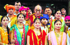 Students pose with the Dalai Lama on the occasion of his 75th birthday at McLeodganj, near Dharamsala, on Tuesday. 