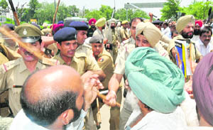Members of the Chandigarh Industrial Area Joint Action Committee being lathicharged by the police near The Tribune Chowk in Chandigarh on Wednesday.