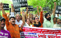 Activists of the Dharamyatra Mahasangh protest against the Jammu and Kashmir government for a newly-introduced Rs 2,000- toll tax on vehicles carrying pilgrims and food items for pilgrims visiting the Amarnath caves, in New Delhi on Wednesday. 