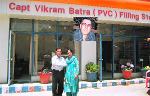 Girdhari Lal Batra and Kamal Kanta Batra, parents of Capt Vikram Batra (inset), at the petrol station allotted to them in Palampur. Photo by writer