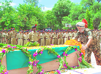 BSF DGP PS Sidhu pays homage to a jawan at the BSF headquarters at Paloura in Jammu on Wednesday. The jawan was killed when Pakistan troops fired in the Pargawal sub-sector in Akhnoor. 
