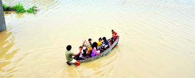 A makeshift boat becomes the lifeline for residents of Urna village, which has been cut off from the world