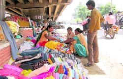 A woman sells clothes under a flyover in Ludhiana