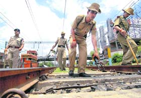 Railway Protection Force personnel inspect a track during the 48-hour bandh called by Maoists, in Patna