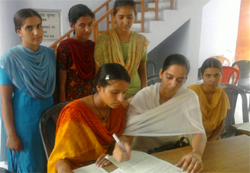 A student fills up the admission form at the LBS College in Barnala