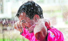 A match refree conducts a match at the District Football League as it rains in Dehradun on Thursday.