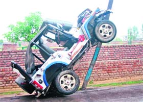 A jeep rests on a pole after it met with an accident on the Circular Road in Rohtak