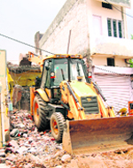 An illegal building being demolished by the MC at Samrala Chowk