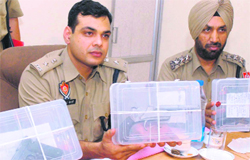 SSP (Rural), Jalandhar, Ashish Chaudhary shows weapons seized from the gang of contract killers in Jalandhar