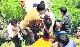 Locals take out bodies of victims from Alaknanda river in Chamoli district of Garhwal on Friday.