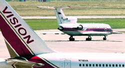 A Russian aircraft (left) rolls on a runway to prepare for takeoff, as an aircraft of the United States stands on the tarmac, after an exchange of spies at Vienna airport on Friday