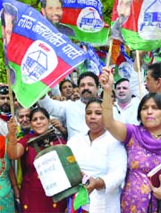 Activists of the Lok Janshakti Party hold an LPG cylinder during their protest against the hike in prices of essential commodities at Jantar Mantar in New Delhi on Saturday.