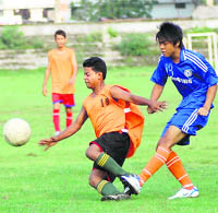 Players vie for the ball at the Lala Nemi Dass District Football League in Dehradun on Saturday.
